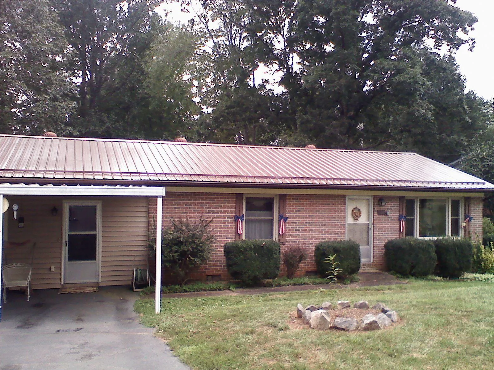 Bronze metal roof and carport on a brick ranch home — Roof Repair work by our crew in South Windsor